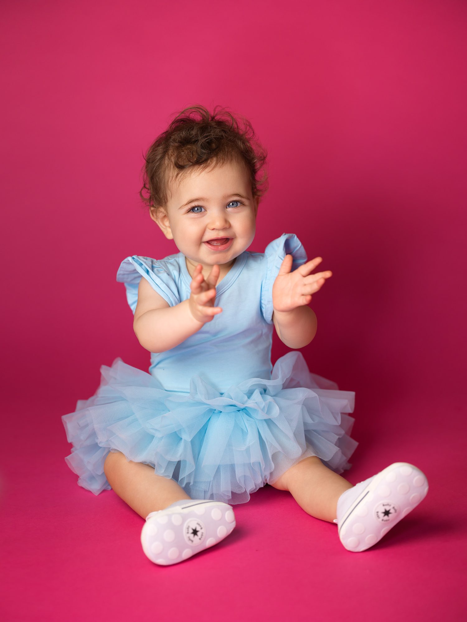 Baby girl on a bold pink backdrop, baby headshot at ColorPop Kids in Los Angeles