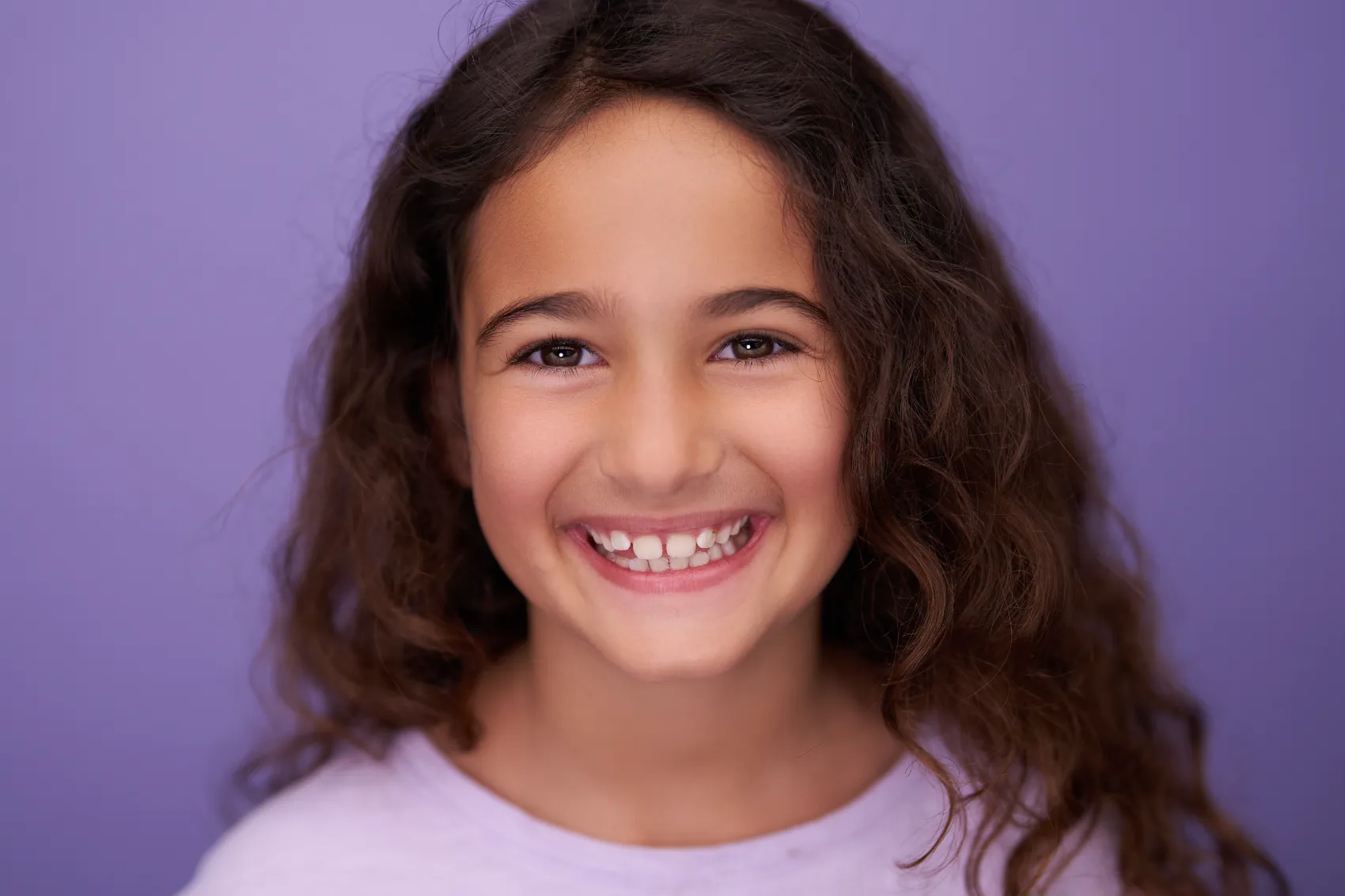 Girl laughing on a lilac backdrop, child actor headshot, ColorPop Kids Los Angeles