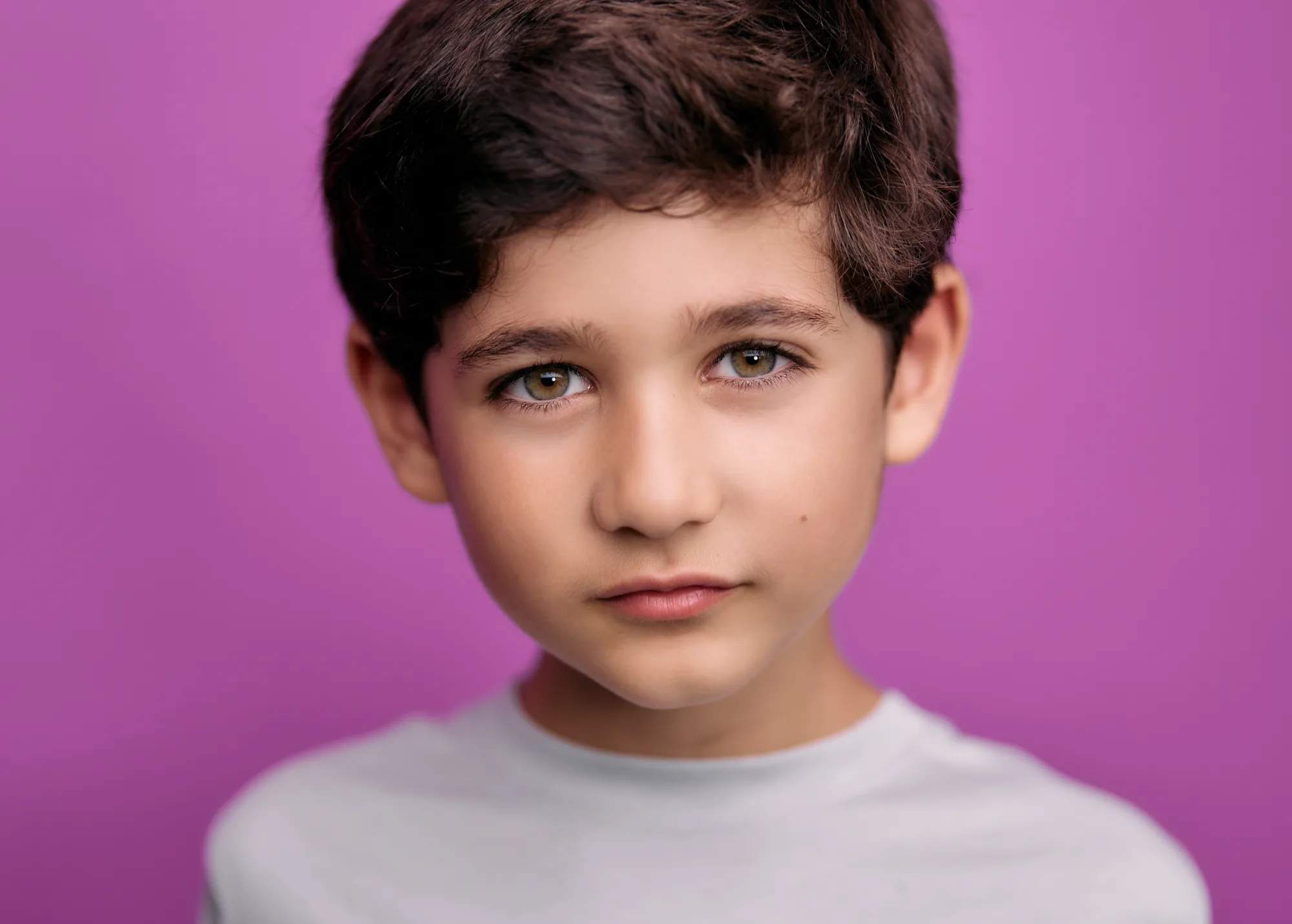 Boy on a bold pink backdrop, kids headshot by ColorPop Kids in Los Angeles