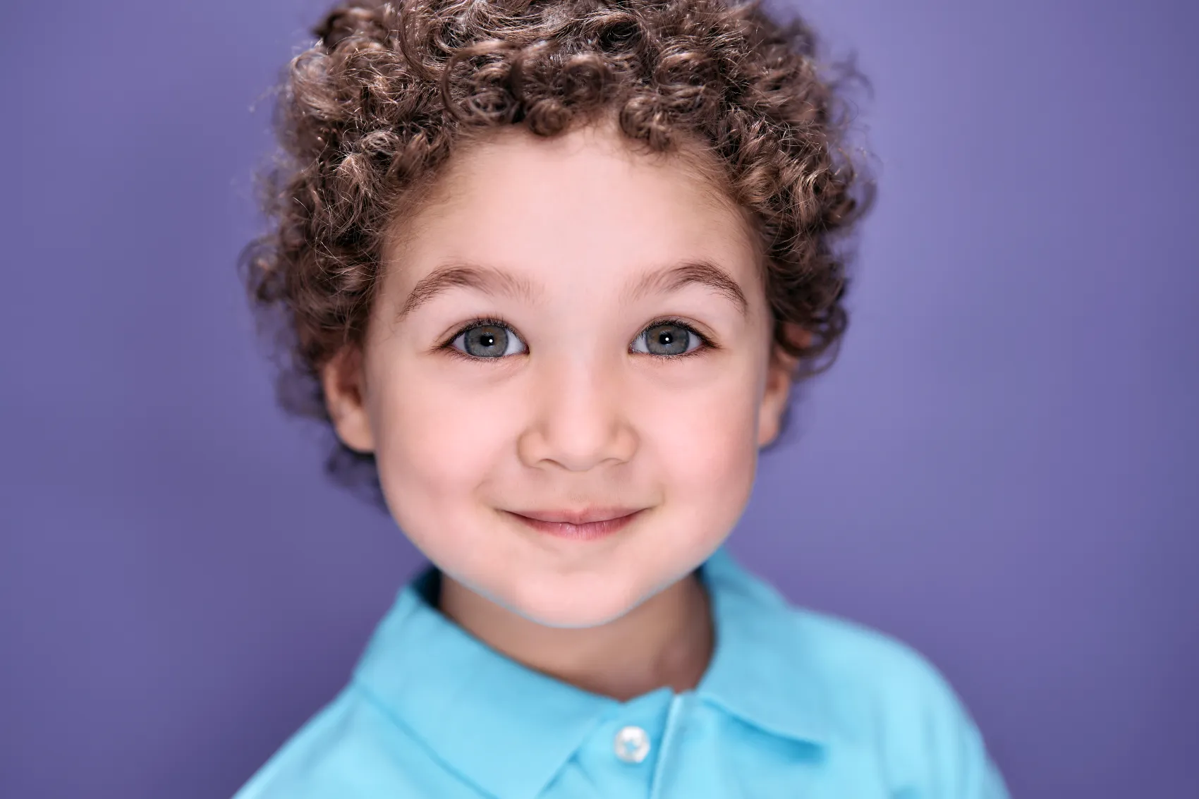 Toddler on a bold purple backdrop, toddler headshot at ColorPop Kids, Los Angeles